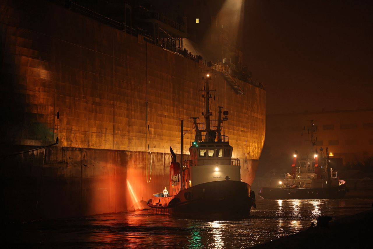 LUBMIN, GERMANY - DECEMBER 16: Tugboats guide the "Neptune," a Norwegian-flagged FSRU ship, backwards into Lubmin Port to a new terminal for importing liquified natural gas (LNG) on December 15, 2022 in Lubmin, Germany. The Neptune is a floating facility for converting LNG back into gaseous form. The ship will enable Germany to use the existing Nordstream 1 landing point, which had previously been used to import natural gas from Russia via the Nordstream 1 underwater pipeline, for pumping natural gas arriving by ship into the German natural gas pipeline network. Germany is building several LNG terminals along its northern coasts as it seeks new ways of importing gas now that supplies from Russia have mostly stopped. (Photo by Sean Gallup/Getty Images)