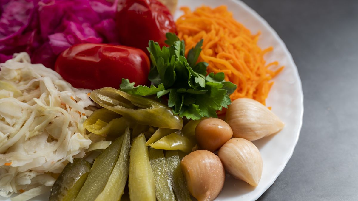assorted pickled vegetables with cabbage and tomatoes with cucumbers on a plateassorted pickled vegetables with cabbage and tomatoes with cucumbers on a plateSheviakova katerynacuisine, closeup, traditional, diet, background, green, canned, wooden, natural, white, vegetarian, fresh, assorted, vegetables, pickling