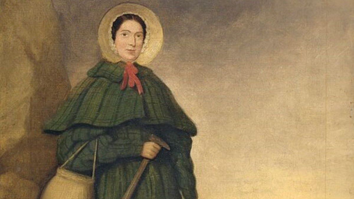 Mary Anning z narzędziami do poszukiwania skamieniałości i psem Tray.