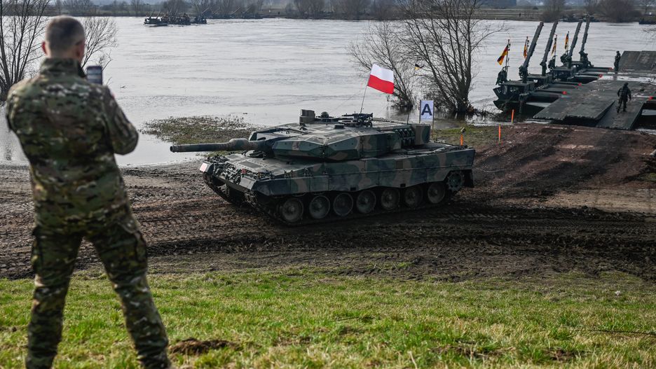KORZENIEWO, POLAND - MARCH 04: Polish soldiers drive a Leopard 2PL tank after crossing the Vistula River on a mobile platform during the DRAGON-24 NATO military defense drills on March 04, 2024 in Korzeniewo, Poland. In the first half of 2024, NATO is conducting a series of exercises under the Steadfast Defender 24 (STDE-24) drill. The exercises, which will take place mainly in Central Europe, will involve some 90,000 troops from all NATO countries as well as Sweden. (Photo by Omar Marques/Anadolu via Getty Images)