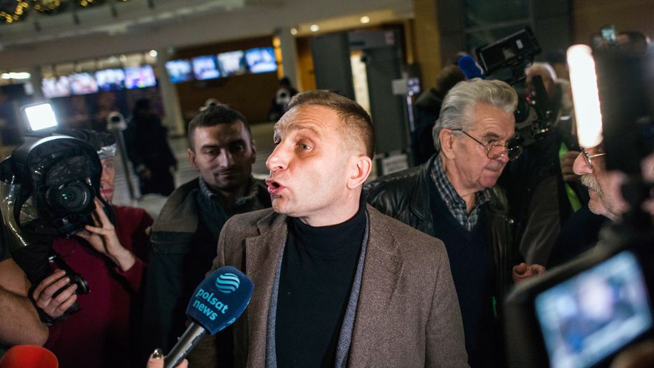 WARSAW, POLAND - 2023/12/20: Robert Bakiewicz, an ultra-nationalist activist speaks to the press during a sit-in protest at the state TV (TVP) headquarters. Poland's new pro-European Union government said Wednesday that it had changed the directors of state television in Poland known as TVP, radio, and the government-run news agency as it embarked on the path of freeing publicly-owned media from the political control of the previous nationalist conservative administration. The Cabinet of Prime Minister Donald Tusk, which took office last week, has made it a priority to restore objectivity and free expression in state media, which the previous government, under the Law and Justice party (PiS), used as aggressive propaganda tools, attacking Tusk and the opposition and spreading its euro skeptical views. Members of Parliament and the ousted former government staged a sit-in inside a building in Warsaw that houses the studios and offices of state TV (TVP). (Photo by Attila Husejnow/SOPA Images/LightRocket via Getty Images)