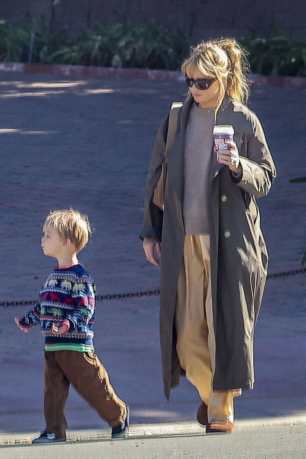 Jennifer Lawrence hides her baby bump while out for a walk with her son.