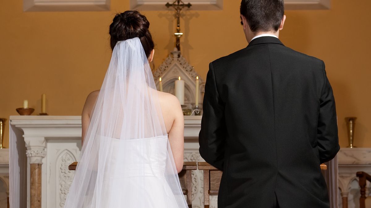 bride and groom in the churchbride and groom in the church kneeling,, waiting for the priestMediaProductionCouple - Relationship, Beautiful, Femininity, Young Couple, Young Women, Women, Females, Males, Two People, Catholicism, Wedding Dress, Veil, Wedding Ceremony, Bridegroom, Bride, 20-29 Years, Young Adult, Kneeling, Waiting, Beauty, Caucasian Ethnicity, Joy, Happiness, Romance, Love, Elegance, White, Irish Culture, Inside Of, Life Events, Lifestyles, Indoors, Vertical, Rear View, Loving, Brown Hair, People, Republic of Ireland, Church, Wedding, Celebration Event, Dress