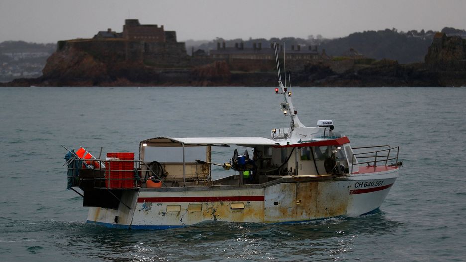 arch45A French fishing boat, one of several boats, protest in front of the port of Saint Helier off the British island of Jersey to draw attention to what they see as unfair restrictions on their ability to fish in UK waters after Brexit, on May 6, 2021. - Around 50 French fishing boats gathered to protest at the main port of the UK island of Jersey on May 6, 2021, amid fresh tensions between France and Britain over fishing. The boats massed in front of the port of Saint Helier to draw attention to what they see as unfair restrictions on their ability to fish in UK waters after Brexit, an AFP photographer at the scene said. (Photo by Sameer Al-DOUMY / AFP)SAMEER AL-DOUMY