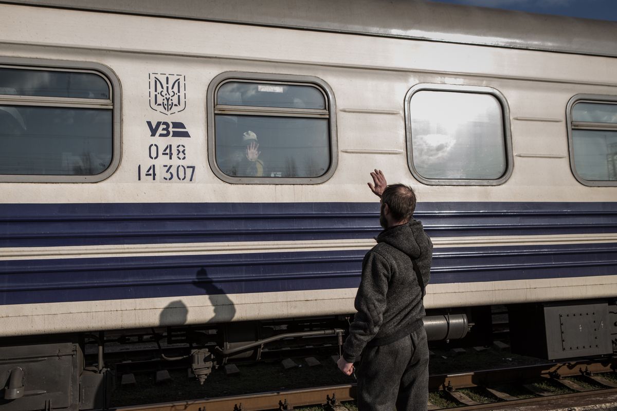 KRAMATORSK, UKRAINE - APRIL 6: A man waves at his relative after boarding a train as civilians are being evacuated from combat zones in Kramatorsk, Donetsk Oblast, in eastern Ukraine on April 6, 2022. Civilians search to board the first available train headed west. (Photo by Andrea Carrubba/Anadolu Agency via Getty Images)