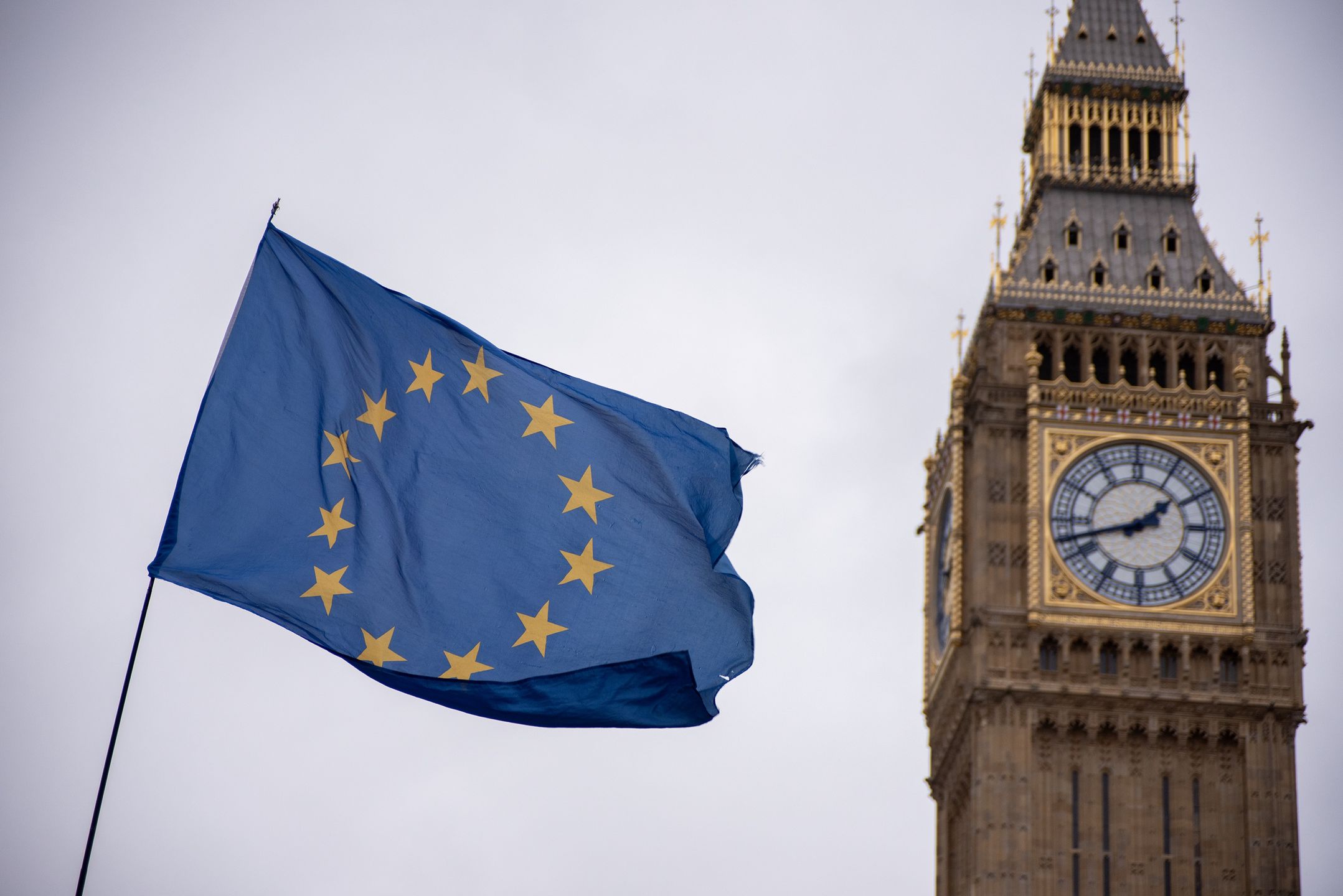 LONDON, UNITED KINGDOM - 2023/12/13: The EU flag is seen flying by Big Ben during a demonstration in London. Pro-EU activists gathered for their weekly Wednesday protest outside the Palace of Westminster in London. They are demonstrating against what they perceive as inhumane treatment of immigrants under the Tory Government's policies. The protesters are calling for a general election and advocating for the UK to rejoin the EU. (Photo by Krisztian Elek/SOPA Images/LightRocket via Getty Images)