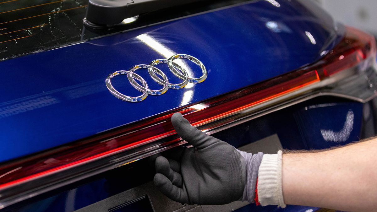 The badge of an Audi Q4 e-tron electric vehicle (EV) on the assembly line at the Volkswagen AG (VW) electric automobile plant in Zwickau, Germany, on Tuesday, April 26, 2022. The Zwickau assembly lines are the centerpiece of a plan by VW, the world's biggest automaker, to manufacture as many as 330,000 cars annually. Photographer: Krisztian Bocsi/Bloomberg via Getty Images