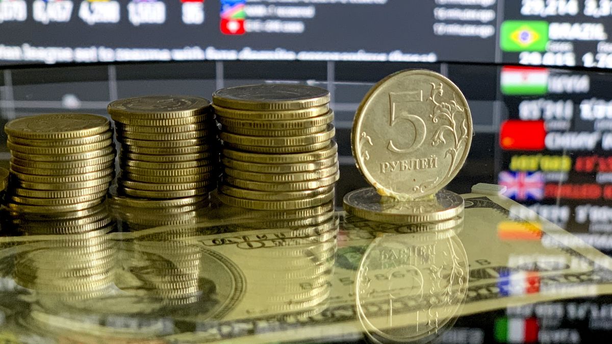 MOSCOW, RUSSIA - APRIL 16: Russian ruble coins and one hundred dollars are seen with Coronavirus Pandemic COVID - 19 Live World Map / Count board in Moscow, Russia on April 16, 2020. The Russian economy has been rocked by the coronavirus outbreak, and the breakdown of the OPEC+ oil production pact between Russia and Saudi Arabia. The turmoil has shocked traders around the world and resulted in sharp volatility on the Russian stock markets and swings in the value of the ruble. (Photo by Sefa Karacan/Anadolu Agency via Getty Images)