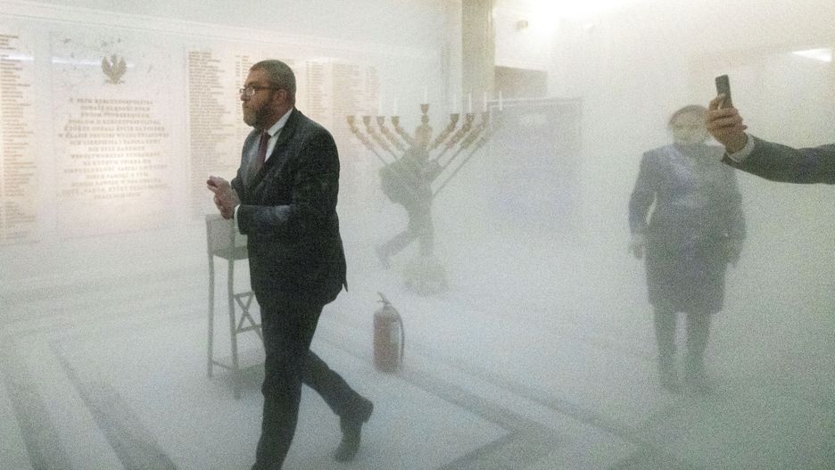 Grzegorz Braun, a far-right Polish lawmaker, is using a fire extinguisher on Hanukkah candles in parliament in Warsaw, Poland, on December 12, 2023. (Photo by Andrzej Iwanczuk/NurPhoto via Getty Images)