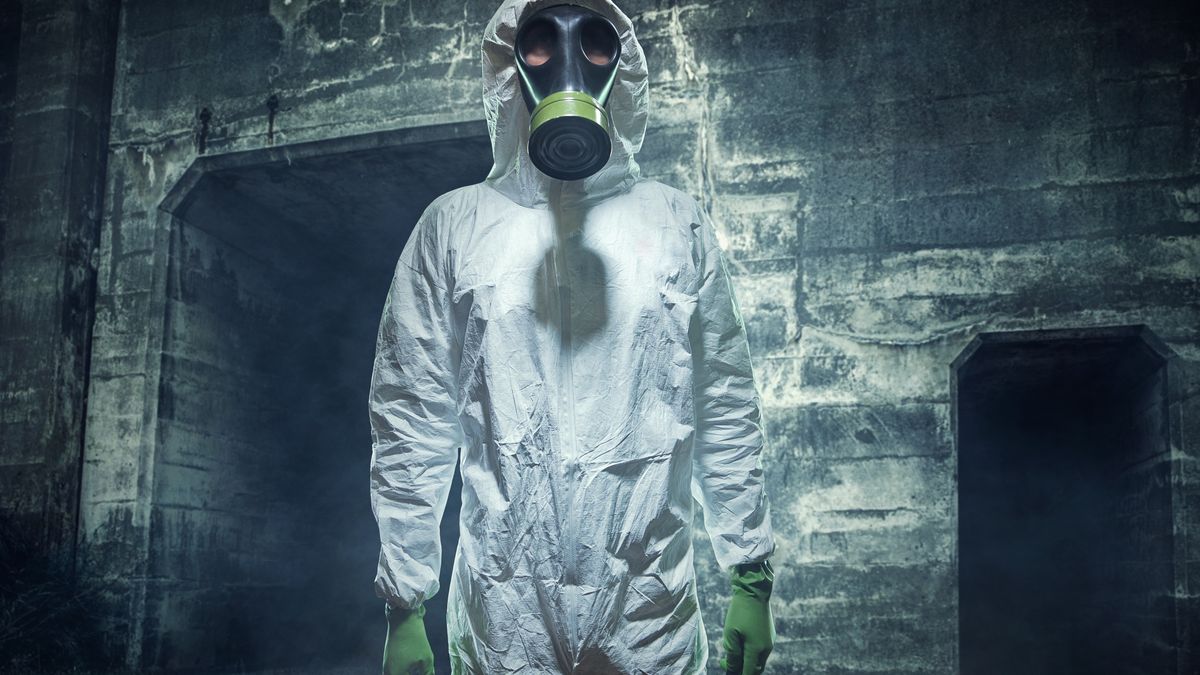 Post Apocalyptic Biological Wasteland ManA man in a Hazmat protective suit, gas mask, and gloves stands in a barren smoke filled futuristic wasteland, the result of natural causes, or nuclear holocaust...RyanJLaneStereotypical, Biochemical Warfare, Protective Suit, Clean Suit, Men, Copy Space, Air Pollution, Forecasting, Judgement Day, Radiation Protection Suit, Mask, Rifle, Burnt, Gas Mask, One Person, Mask, Run-Down, Ruined, Demolished, Futuristic, Cool, Disaster, Dark, Damaged, Dirty, Bad Condition, Wide-Angle Lens, Horizontal, Natural Disaster, Smoke, Barren, Pollution, Bomb Damage, Environmental Damage, Grunge, Gas, Concepts And Ideas, Lifestyle, People, Adults, Post Apocalyptic, Bio Warfare