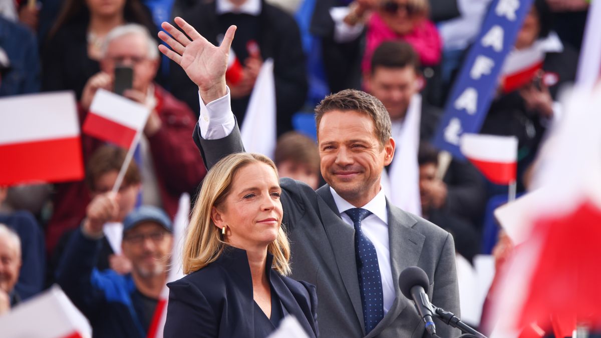 Rafal Trzaskowski, the mayor o Warsaw and the candidate of the Civic Platform (PO) in the upcoming presidential election, and his wife Malgorzata Trzaskowska, attend a campaign rally at the Main Square in Krakow, Poland on May 13, 2025.  (Photo by Beata Zawrzel/NurPhoto via Getty Images)