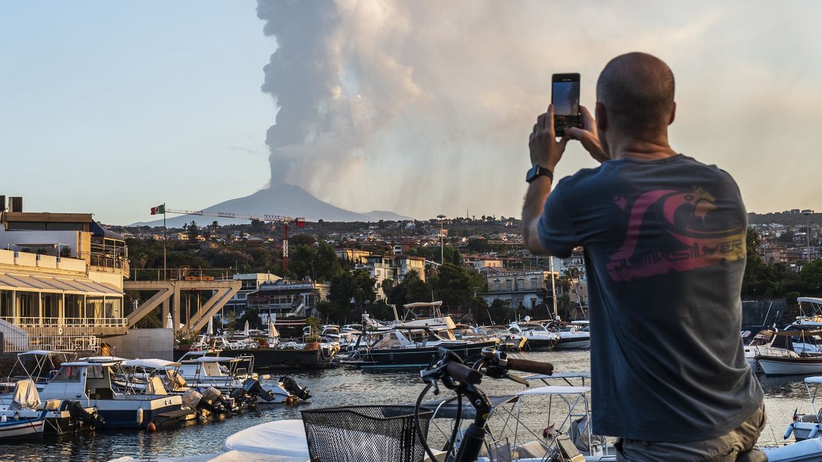 Mount Etna Spews Lava And Ash In New EruptionCATANIA, ITALY - AUGUST 04: A man on a bicycle pauses to photograph the spectacular eruption of Mount Etna seen at dawn from the small port of Ognina on August 04, 2024 in Catania, Italy. Mount Etna's latest eruption spewed kilometre-high fountains of lava from the Voragine crater as the wind blew east-northeast spreading ash emissions on the villages on the north-eastern slope. (Photo by Fabrizio Villa/Getty Images)Fabrizio Villa