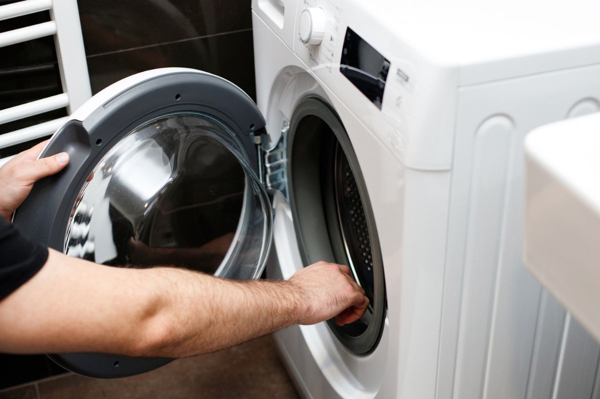 The man opens the washing machine.