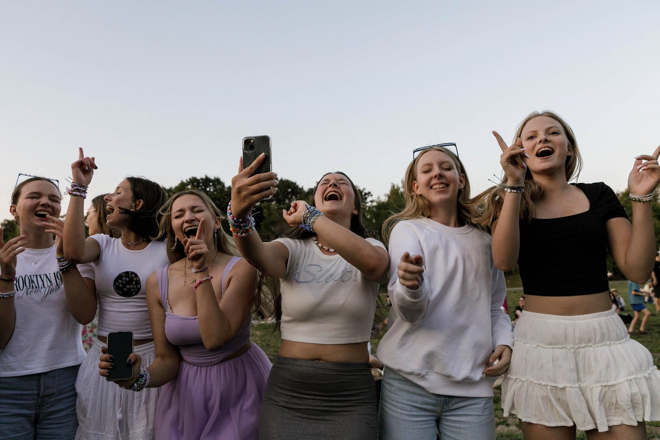 WARSAW, POLAND - 2024/08/01: Taylor Swift's fans are singing and dancing holding their mobile phones outside the National Stadium during the Eras Tour. American singer Taylor Swift will play three concerts in Warsaw, Poland on August 1, 2, and 3 as part of her Eras Tour at the National Stadium (PGE Stadion Narodowy). Thousands of people from Poland and other countries will attend the concert. However, some fans, known as Swifties, who did not secure tickets gathered around the stadium to hear the star. (Photo by Volha Shukaila/SOPA Images/LightRocket via Getty Images)