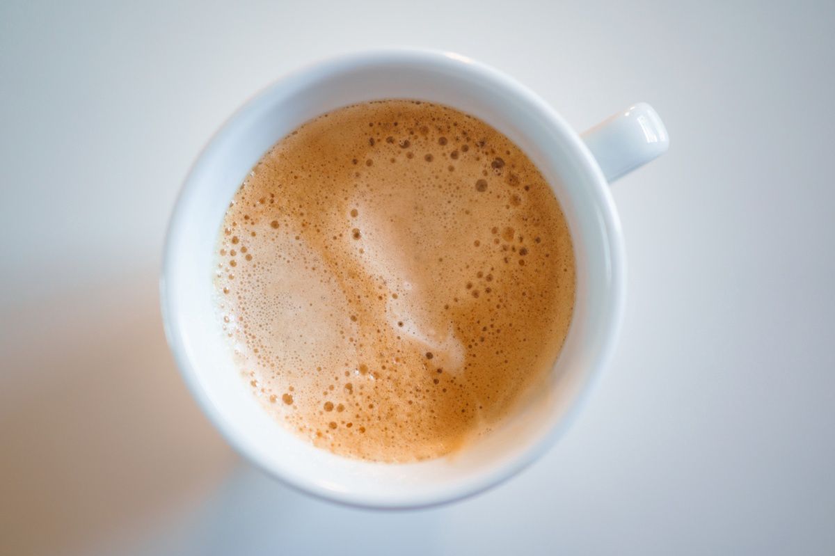 A mug of coffee with milk and sugar