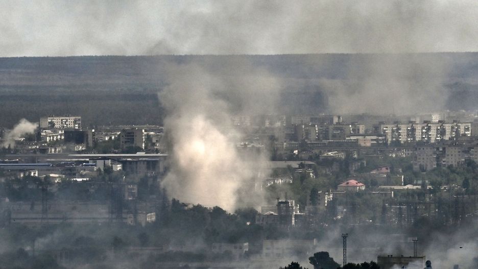 TemporarySmoke and dirt rise from shelling in the city of Severodonetsk during fight between Ukrainian and Russian troops in the eastern Ukrainian region of Donbas on June 7, 2022. (Photo by ARIS MESSINIS / AFP)ARIS MESSINIS