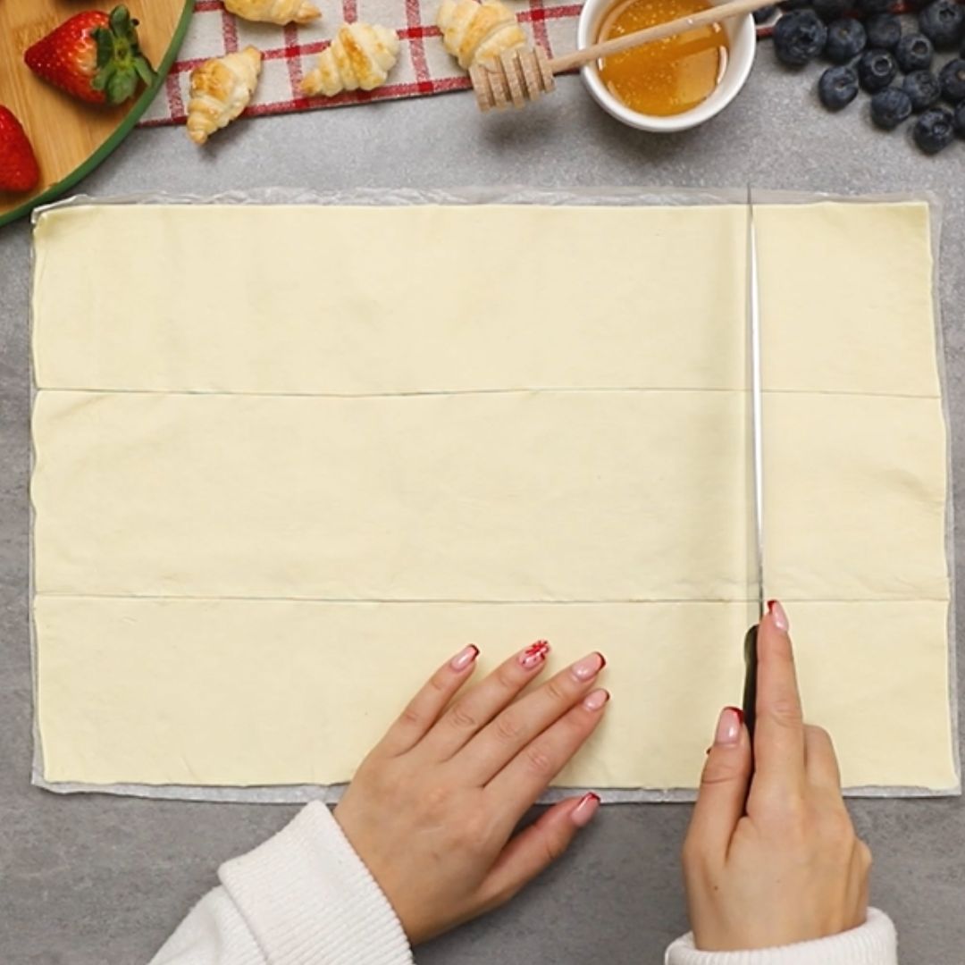 First, I divide the dough into smaller squares.