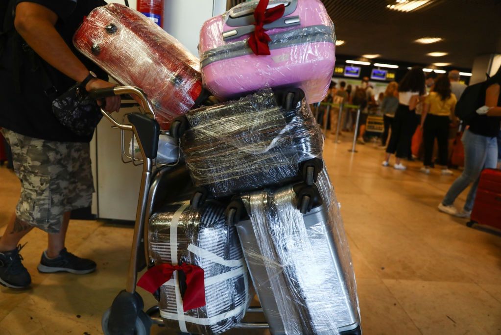 Plastic-wrapped luggage: Security boost or environmental blunder?