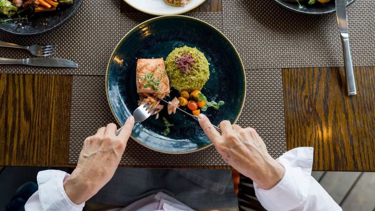 Close-up on a woman eating salmon for dinner at a restaurant
Close-up on a woman eating salmon for dinner at a restaurant - food and drink concepts
Hispanolistic