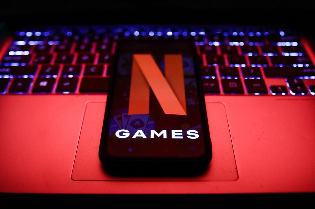 Netflix Games logo displayed on a phone screen and a laptop keyboard are seen in this illustration photo taken in Poland on November 4, 2021. (Photo by Jakub Porzycki/NurPhoto via Getty Images)