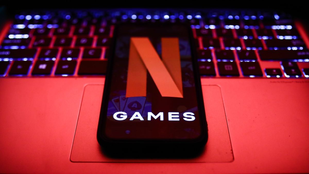 Netflix Games logo displayed on a phone screen and a laptop keyboard are seen in this illustration photo taken in Poland on November 4, 2021. (Photo by Jakub Porzycki/NurPhoto via Getty Images)