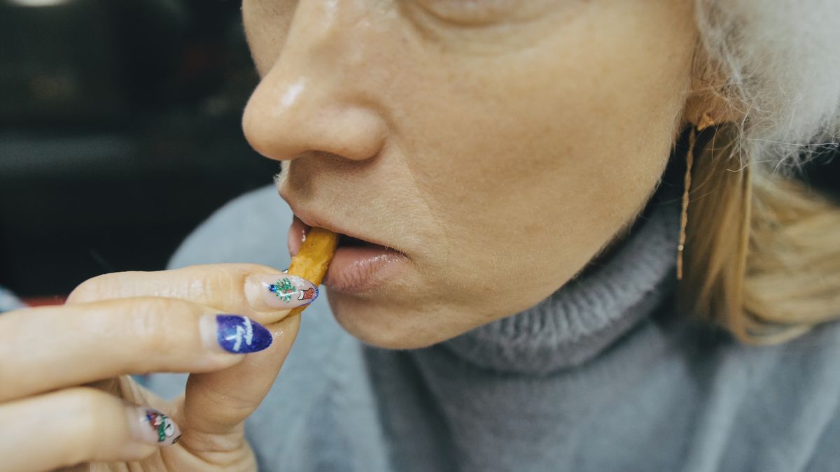 Girl eat pizza and french fry potato. Close up of young woman mouth greedily eating pizza and chewing in outdoor restaurant.
Girl eat pizza and french fry potato. Close up of young woman mouth greedily eating pizza and chewing in outdoor restaurant. Human hands taking pieces slices of hot tasty italian pizza from open box.
ivandan