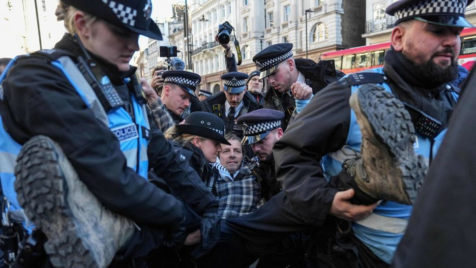Temporary
Police remove a protester (C) who was taking part in a demonstration in support of "Defend Our Juries" and their campaign against the ban on Palestine Action, outside the Royal Courts of Justice, Britain's High Court, in central London on November 26, 2025. The co-founder of activist group Palestine Action will on November 26 challenge a UK government ban under anti-terror laws that has led to mass arrests, sparking free speech and civil liberties concerns. (Photo by CARLOS JASSO / AFP)
CARLOS JASSO
