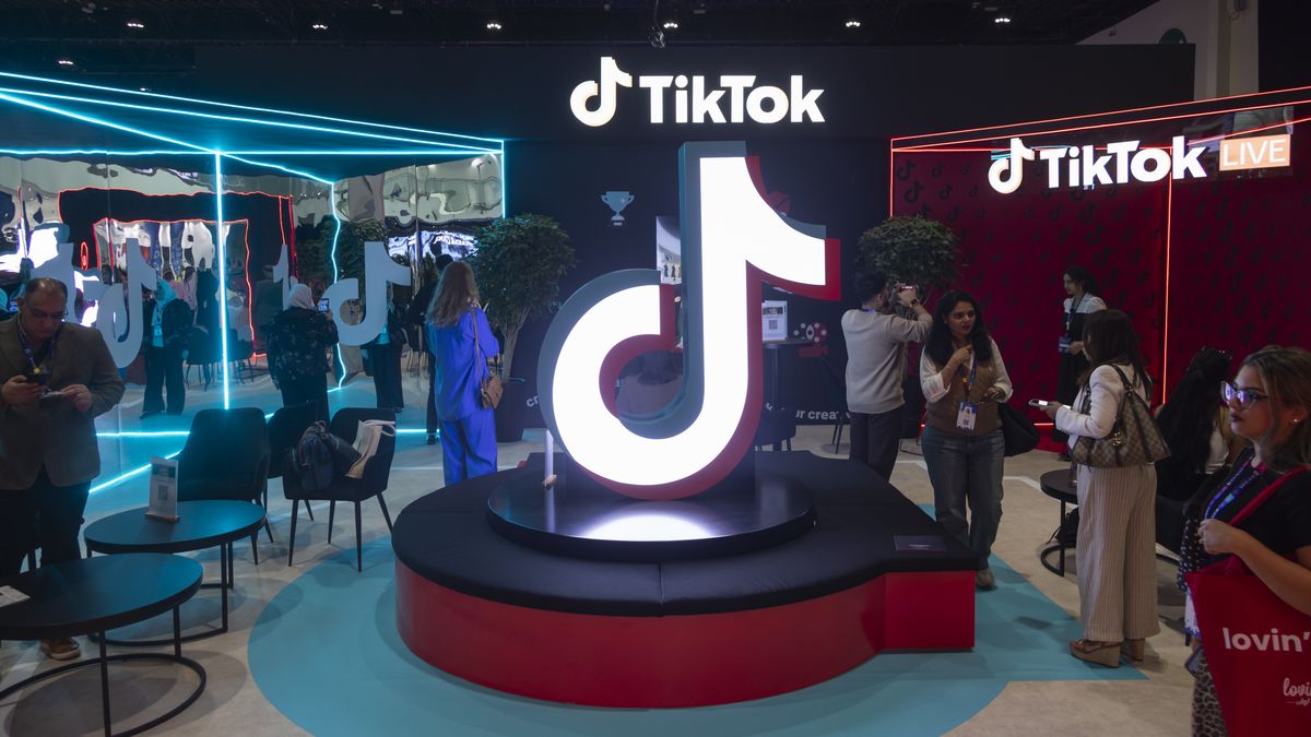 TikTok exhibition stand with the logo of the social media video platform illuminating while people attending. TikTok has become one of the world's most popular social media platforms, using recommendation algorithms to connect content creators and influencers with new audiences with more than 2 billion mobile downloads worldwide. TikTok Ltd is based in Singapore and Los Angeles owned by the Beijing based parent company ByteDance and Chinese Investors. Tech companies booths at the BRIDGE Summit 2025 at Abu Dhabi National Exhibition Centre ADNEC. BRIDGE Summit in the UAE is a major global media, entertainment, and technology conference. Abu Dhabi, United Arab Emirates on December 10, 2025.  (Photo by Nicolas Economou/NurPhoto via Getty Images)