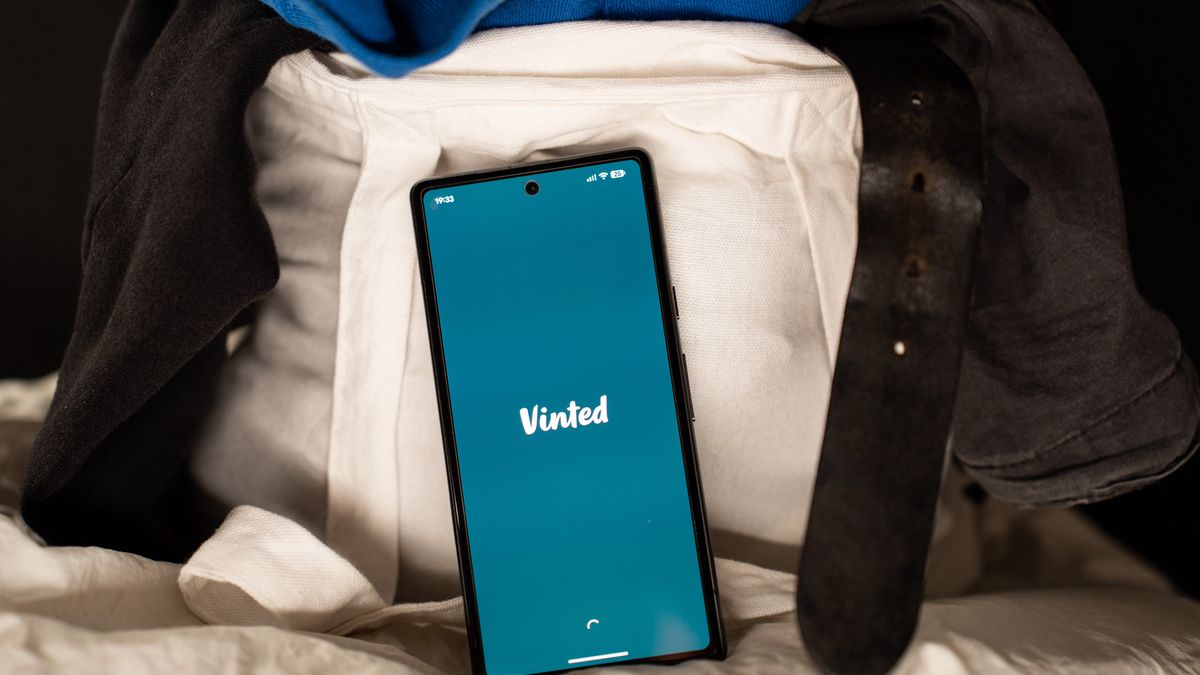 The Vinted logo is displayed on a smartphone screen as the phone rests among second-hand clothing inside a tote bag in this illustration photo in Athens, Greece, on February 15, 2026. (Photo by Nikos Pekiaridis/NurPhoto via Getty Images)