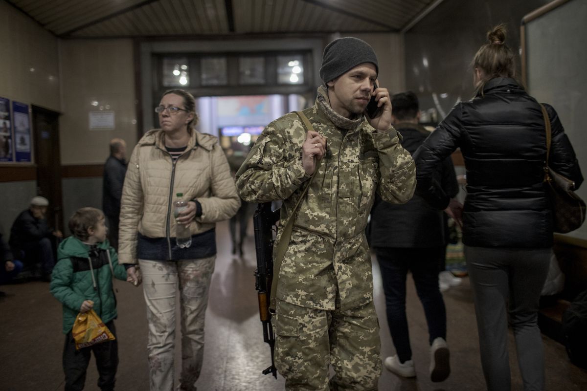 LVIV, UKRAINE â APRIL 9: Civilians, from the eastern part of the country continue to arrive Lviv, and some of them return their homes in Kyiv and Odessa, and a foreign volunteer fighters on the side of Ukraine are seen at Lviv train station in Lviv, Ukraine on April 9, 2022. Intense movement of civilians continue due to war that started with Russian attacks on Ukraine. Support desk is set up by volunteers to help elderly or disabled people and to provide food, shelter and psychological support to refugees at Lviv train station. (Photo by Ozge Elif Kizil/Anadolu Agency via Getty Images)