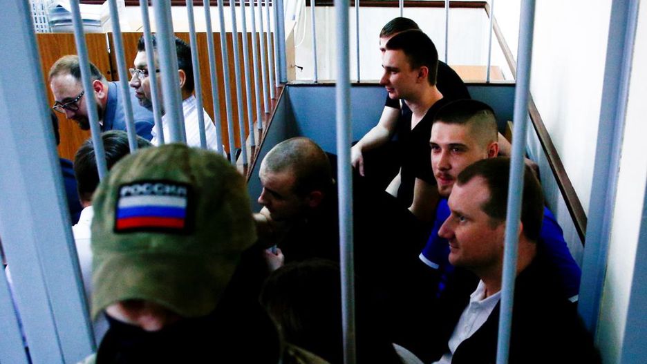 Court hearing of Ukrainian sailors in MoscowMOSCOW, RUSSIA - JULY 17: Ukrainian sailors sit inside a defendants' cage prior to a hearing at Lefortovo Court in Moscow, Russia on July 17, 2019. - The court will decide whether to continue to hold 24 Ukrainian sailors captured last November. Russia seized three Ukrainian navy vessels, capturing the sailors near the Kerch Strait as they tried to pass from the Black Sea to the Azov Sea. Sailors were brought in groups to the court. (Photo by Sefa Karacan/Anadolu Agency/Getty Images)Anadolu AgencyRussia, trial, politics, horizontal, Defendant, captured, court, hearing, photography, sailor, Politics and Government, Moscow - Russia, Lefortovo Court, FeedRouted_Global
