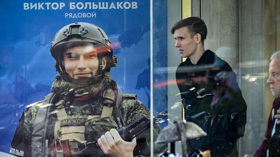 Temporary
Men wait at a bus stop next to a poster displaying Russian Army Privat Viktor Bolshakov, participating in Russia's military action in Ukraine, in central Moscow on August 5, 2024. (Photo by Alexander NEMENOV / AFP)
ALEXANDER NEMENOV