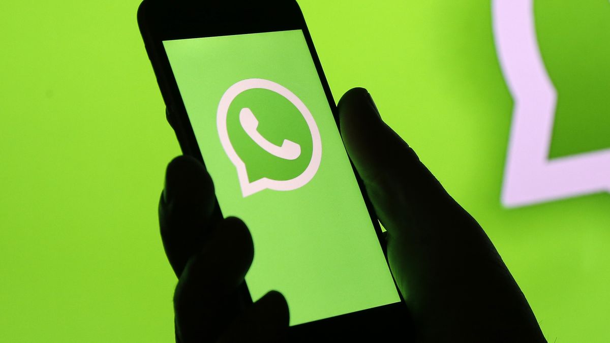 PARIS, FRANCE - DECEMBER 10: In this photo illustration, the WhatsApp logo is displayed on the screen of an iPhone in front of a TV screen displaying the WhatsApp logo on December 10, 2019 in Paris, France. The WhatsApp instant messenger service will stop working on millions of phones in the next couple of months as the company withdraws support for some older mobile platforms. From February 1, 2020, any iPhone running iOS 8 or older will no longer be supported, along with any Android device running version 2.3.7 or older. (Photo by Chesnot/Getty Images)