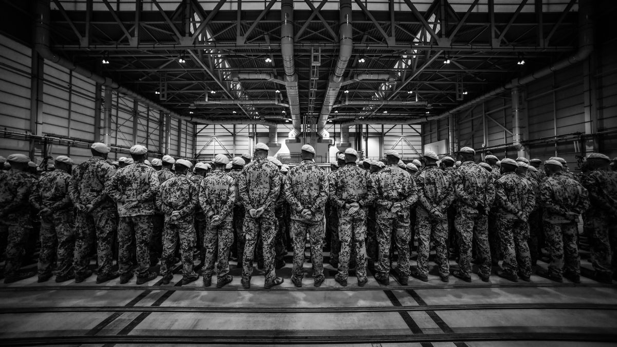 WUNSTORF, GERMANY - DECEMBER 15: (EDITOR´S NOTE: Image was converted from colour into black and white) Soldiers of the Bundeswehr (German Armed Forces) stand in line after leaving an A400m transport plane as they return from Mali on December 15, 2023 in Wunstorf, Germany. Germany is ending its 10-year participation in the multinational United Nations MINUSMA peacekeeping effort in Mali following the termination of the entire mission last summer at the request of the Mali government. (Photo by Alexander Koerner/Getty Images)