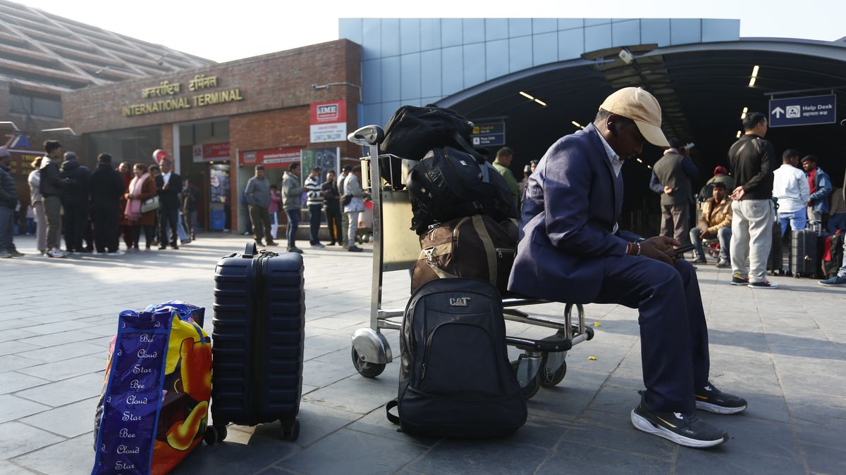 Nepali migrant workers wait in the departure hall of Tribhuvan International Airport after several Middle Eastern nations close their airspace following heightened tensions between Israel and Iran, leading to flight cancellations and delays in Kathmandu, Nepal, on March 1, 2026. (Photo by Sanjit Pariyar/NurPhoto via Getty Images)