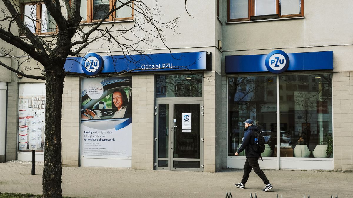 A pedestrian passes a Powszechny Zaklad Ubezpieczen SA (PZU) bank branch in Warsaw, Poland, on Monday, March 20, 2023. Poland's February retail sales fell 5% as prices rose 10.8% from a year earlier, data from the Central Statistical Office in Warsaw shows. Photographer: Damian Lemaski/Bloomberg via Getty Images