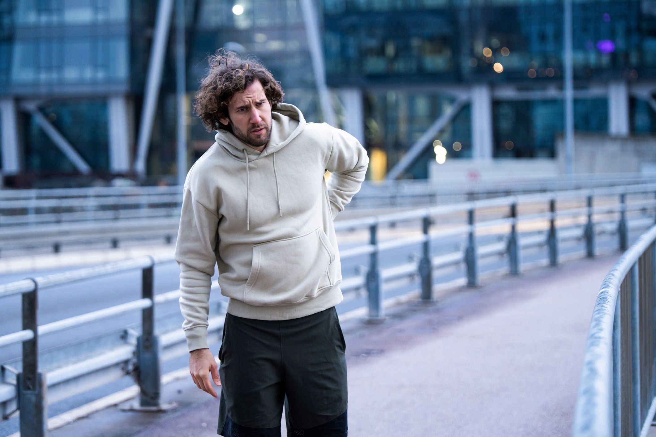 Young male athlete having a backache.
Exhausted young sportsman having a backache while running in the city on cold weather.
DjelicS