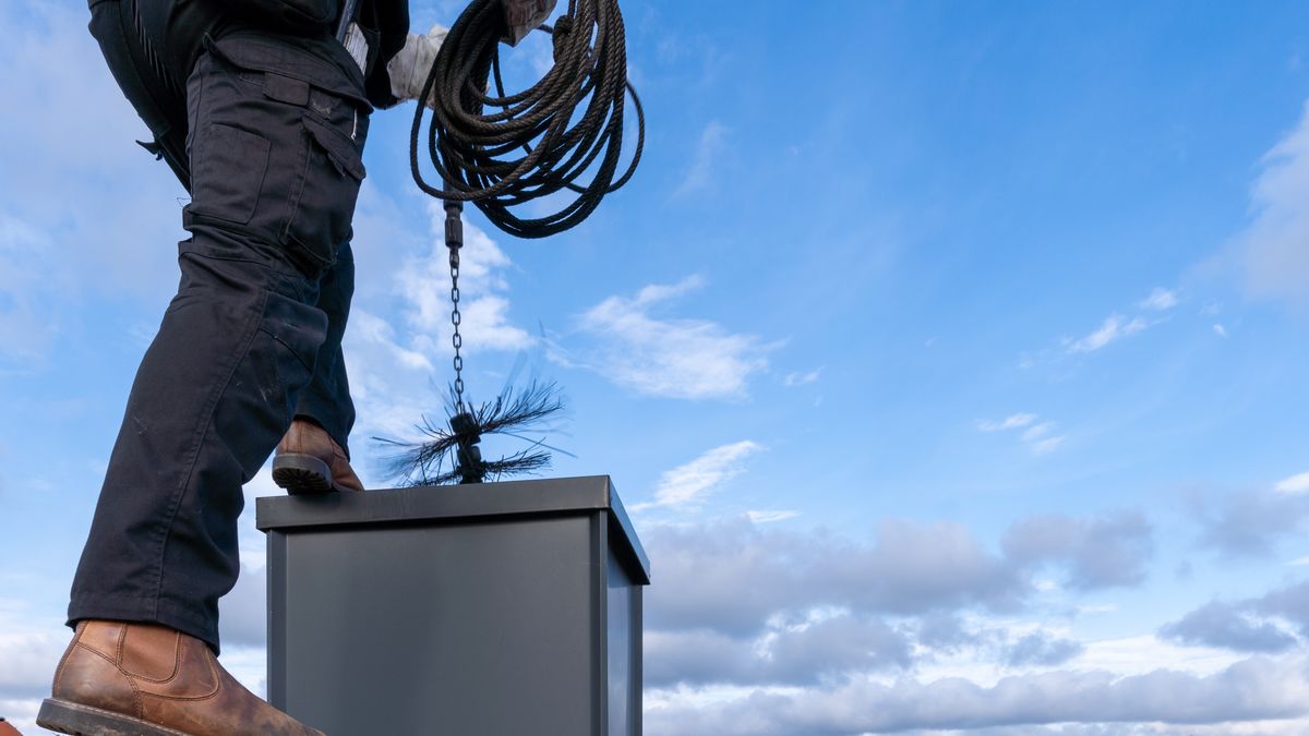 close up of a chimney sweep on the roofChimney sweep man in work uniform cleaning chimney on building roofGabor Tinzchimney, chimney sweep, person, occupation, cleaning, outdoor, man, house, roof, adult, brush, working, rooftop, sweep, equipment, work, sky, standing, black, sweeper, uniform, fireplace, home, clean, broom, one person, craft, male, rope, building, service, maintenance, germany, inspection, professional, chimney, chimney sweep, person, occupation, cleaning, outdoor, man, house, roof, adult, brush, working, rooftop, sweep, equipment, work, sky, standing, black, sweeper, uniform, fireplace, home, clean, broom, one person, craft, male, rope, building, service, maintenance, germany, inspection, professional
