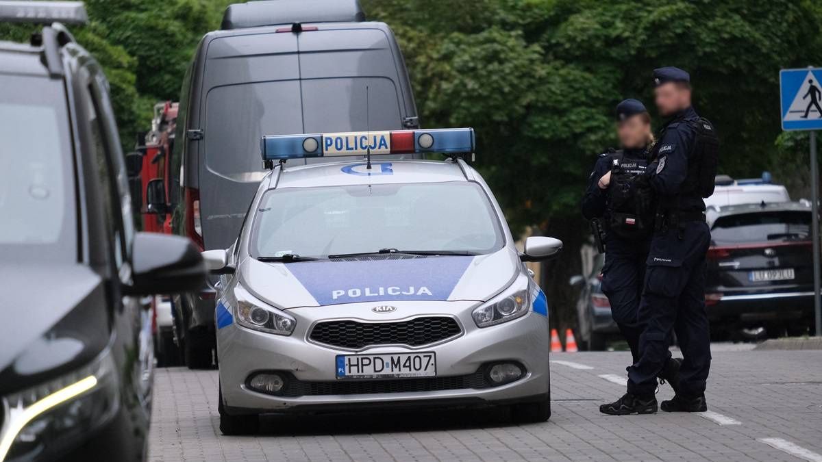 Policjanci stojący przy radiowozie