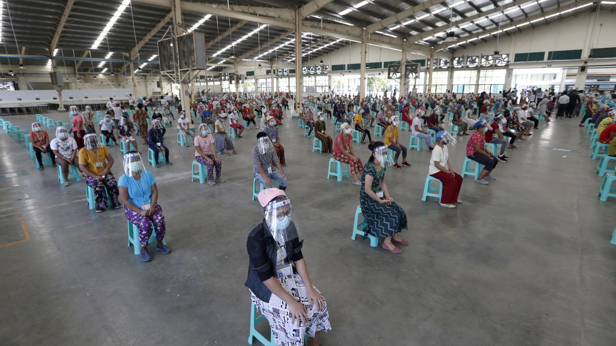 Pracownicy z fabryki butów w Azji czekają na badanie lekarskie.