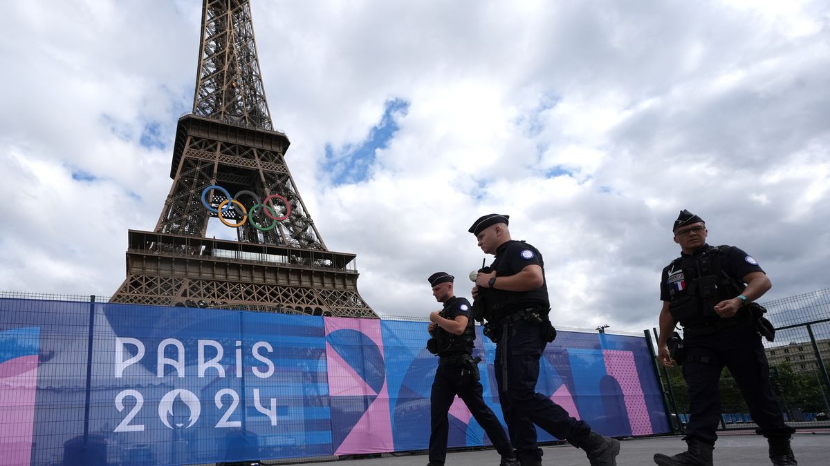 Police officers walk past the Eiffel Tower, Paris. The Opening Ceremony of the Paris 2024 Olympic Games takes place on Friday 26th July, along the River Seine. Picture date: Tuesday July 23, 2024. (Photo by Martin Rickett/PA Images via Getty Images)