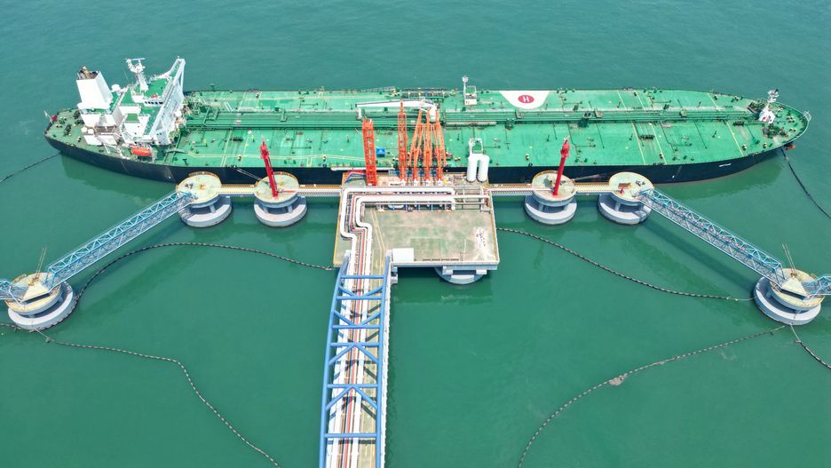 YANTAI, CHINA - MAY 23, 2022 - A tanker is unloaded at a 300,000-ton crude oil terminal in Yantai Port, East China's Shandong province, May 23, 2022. Relying on the "integrated" energy storage and transportation service system, Yantai Port strengthens coordination in shipping schedule tracking, dynamic deployment, production process and other aspects, deeply taps the potential, realizes seamless connection of all links, further releases the port production momentum, and comprehensively guarantees the stability and smooth flow of the energy logistics supply chain. (Photo credit should read CFOTO/Future Publishing via Getty Images)