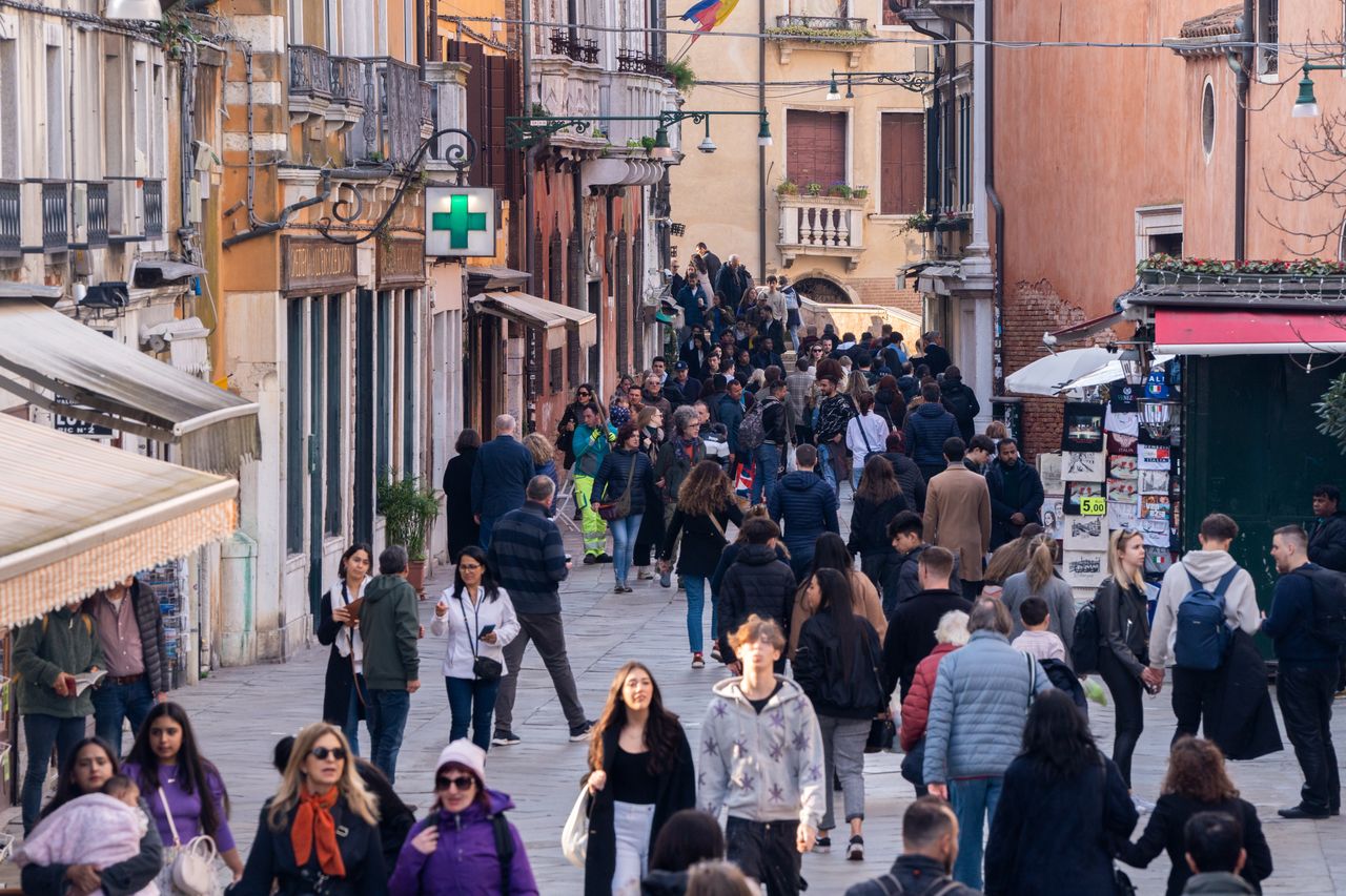 Tourists line a street in Venice, Italy, on Saturday, March 16, 2024. Venice collected 37 million in overnight tourist taxes in 2023, with hotels charging guests anywhere between 1 and 5. Photographer: Nathan Laine/Bloomberg via Getty Images: Nathan Laine/Bloomberg via Getty Images