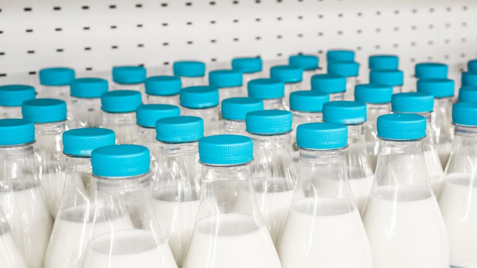 bottles with milk as dairy product for preparing breakfast wait for byers on market shelf