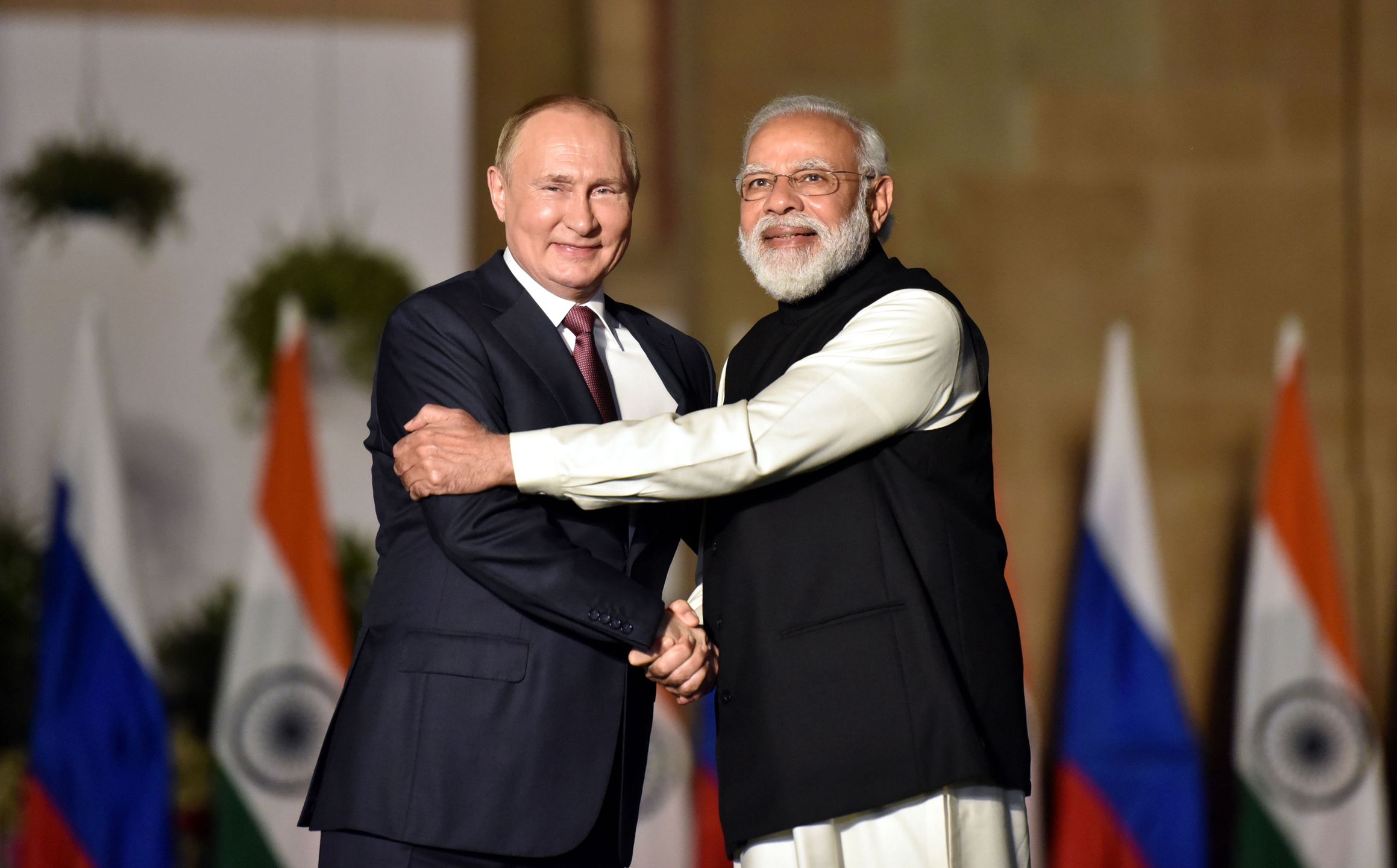 NEW DELHI, INDIA - DECEMBER 6: Indian Prime Minister Narendra Modi shakes hands with Russian President Vladimir Putin during their meeting at Hyderabad House, on December 6, 2021 in New Delhi, India. (Photo by Sonu Mehta/Hindustan Times via Getty Images)
