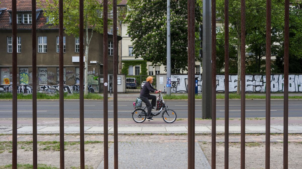 BERLIN, GERMANY - MAY 4: People ride on bikes around the remnants of the original Berlin Wall blocks in the form of iron structures along Bernauer Strasse in Berlin, Germany on May 4, 2025. The Berlin Wall, a key symbol of the Cold War that divided Berlin, was built in 1961 to stop people from fleeing East to West Germany. Known as the "Wall of Shame," it stood for 28 years until mass calls for freedom led to its fall on November 9, 1989. Traces of the wall can still be seen in Berlin today. (Photo by Halil Sagirkaya/Anadolu via Getty Images)
