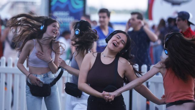 TORONTO, ON - JULY 30  -   Steps away from the music of The Arsenals at the main stage people dance to different music at a silent disco during the Island Soul Festival held at Harbourfront Centre  in Toronto. July 30, 2022. Participants in the silent disco wear headsets that pipe in music from an onsite DJ.        (Steve Russell/Toronto Star via Getty Images)