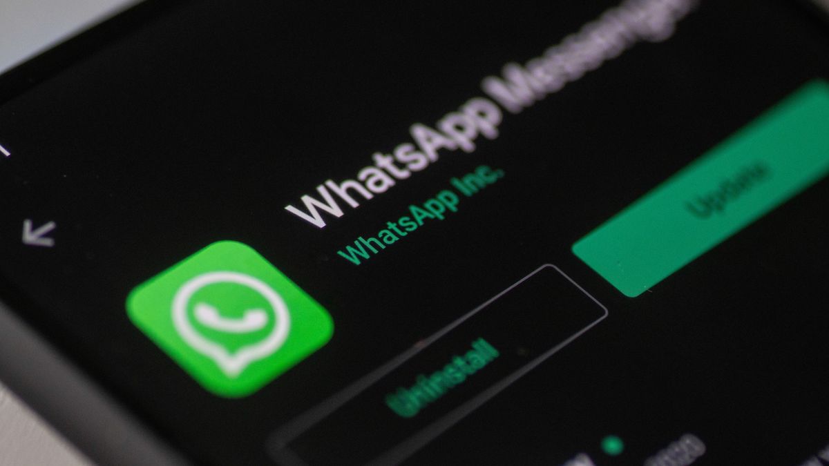 WhatsApp logo displayed on a phone screen, smartphone and keyboard are seen in this multiple exposure illustration. WhatsApp Messenger is a multiplatform mobile application that provides an encrypted instant messaging system belonging to Facebook, photo taken in Amsterdam, Netherlands on January 28, 2020 (Photo illustration by Nicolas Economou/NurPhoto via Getty Images)