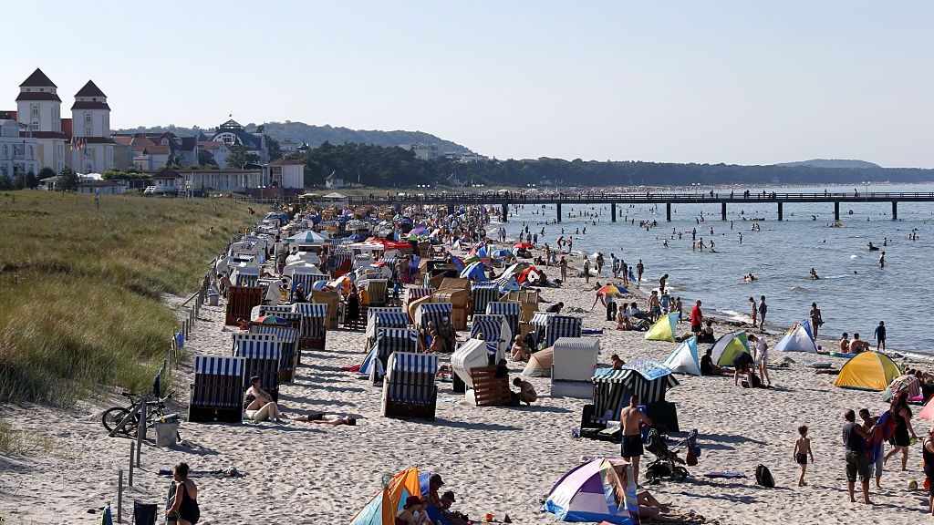 Strand in Binz auf Ruegen
(GERMANY OUT) Urlauber am Strand von Binz auf der Insel Ruegen.  (Photo by Jens Köhler/ullstein bild via Getty Images)
ullstein bild
2022, Western Pomerania, water, Wasser, Vorpommern, verreisen, vacationer, vacation, Urlaubswetter, Urlaubssaison, Urlauber, Urlaub, Umwelt, trip, travel, tourists, Touristen, tourism, the sun, the European Union, the EU, the Baltic Sea, take it easy, sunshine, sunny, summer weather, summer vacation, summer holidays, summer, Strandwetter, Strandurlaub, Strandkorb, Strand, spare time, sonnig, Sonnenschein, sonnenbaden, Sonnenbad, Sonne, Sommerwetter, Sommerurlaub, Sommerferien, Sommer, solar bath, See, sea, schoenes Wetter, sandy beach, Sandstrand, rest, relax, Reiseziel, reisen, Reise, recover, Pommern, Pomerania, person, people, Ostseestrand, Ostseebad, Ostsee, Ostdeutschland, North Germany, Norddeutschland, nice weather, new federal states, new countries, Neue Laender, Neue Bundeslaender, Mensch, Meer, Mecklenburg-West Pomerania, Mecklenburg-Vorpommern, Mecklenburg, mass tourism, Massentourismus, Leute, lake, Kurort, Kueste, island, Insel Ruegen, holiday weather, holiday season, holidays, holiday-makers, Hitze, heat, healthy, health resort, health, have a bath, go away, Gesundheit, gesund, Germany, Fremdenverkehr, Freizeit, Feriengaeste, Ferien, Europe, Europaeische Union, Europa, EU, Erholung, erholen, environment, entspannen, Eastern Germany, Deutschland, destination, coast, Bundeslaender, Binz, beach weather, beach vacation, beach basket, beach, bathing resort, Baltic beach, Badestrand, Badeort, baden, are relaxing, 21st century, 21. Jahrhundert