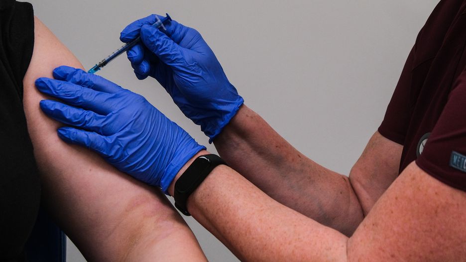 KRAKOW, POLAND - DECEMBER 27 : A health worker receives a BioNTech-Pfizer COVID-19 vaccine during the first day of vaccination on December 27, 2020 in Krakow, Poland. Poland started today to vaccine the medical sector and is expecting 300 thousand vaccines until the end of 2020. (Photo by Stringer/Anadolu Agency via Getty Images)